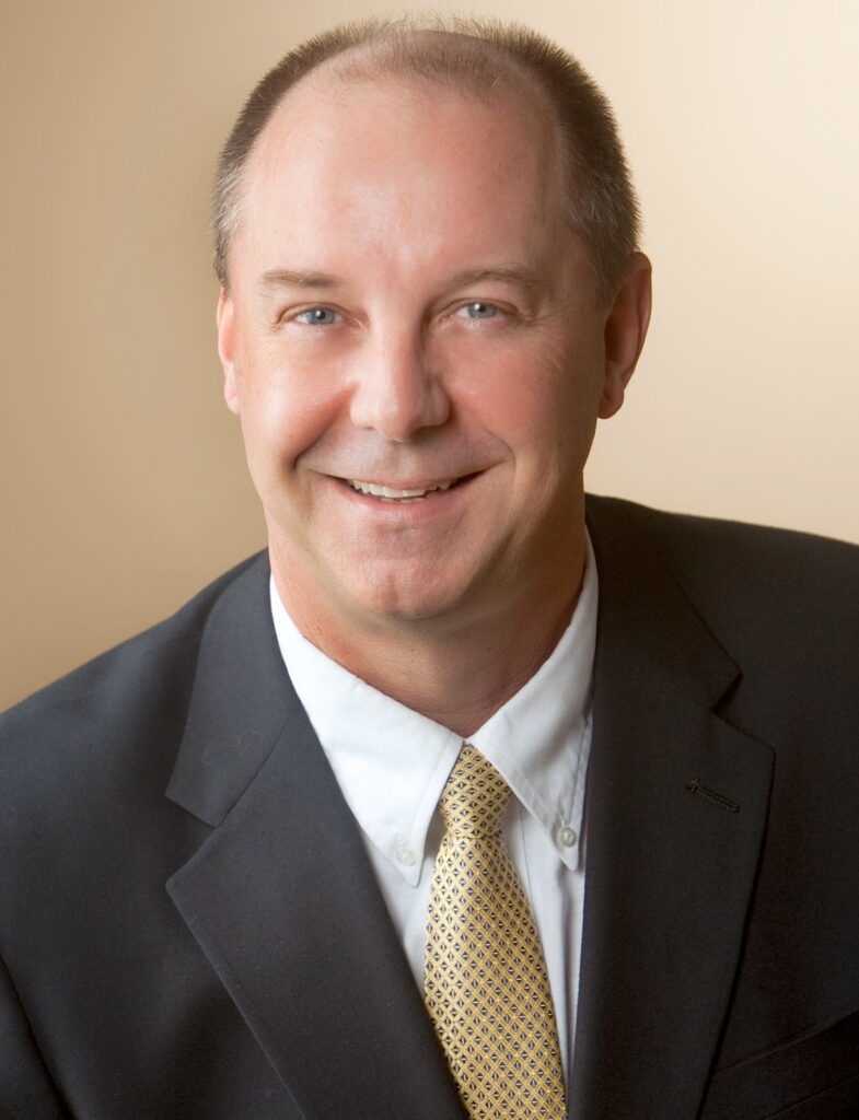 Smiling middle-aged businessman in suit and tie